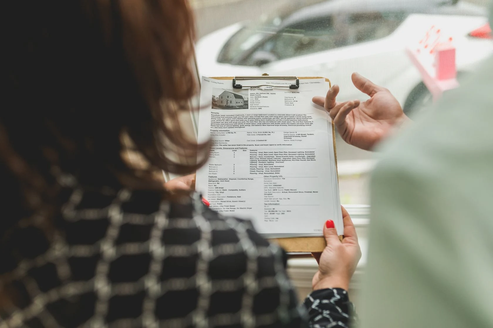 A property adviser reviewing listing documents with a buyer